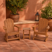 Room | two Teak-tone rocking Adirondack chairs and one slatted side table in a warm terracotta courtyard