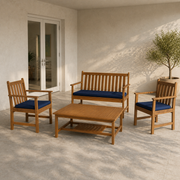 Scale | patio scale view of the natural acacia four-piece conversation set beside a full-height doorway