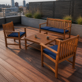 In a room | rooftop deck with natural acacia loveseat, two navy-cushioned armchairs, and coffee table