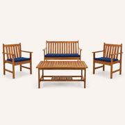Front | studio front view of natural acacia loveseat, two navy-cushioned armchairs, and slatted coffee table