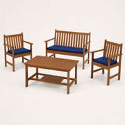 Studio | studio three-quarter view of natural acacia loveseat, two navy-cushioned armchairs, and coffee table