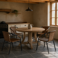 Beamed kitchen | four Medium Brown woven-rattan armchairs around a light wood table on slate tile, window at right