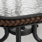 Hardware | extreme close-up of rippled glass, dark-brown woven table edge, and black steel hub