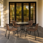 Scale | five-piece patio dining set beside a floor-to-ceiling black-framed glass doorway