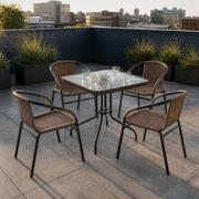 In a room | five-piece dining set on a charcoal city roof terrace with skyline beyond