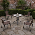 In a room | five-piece dining set on a brick garden patio beside clipped hedges