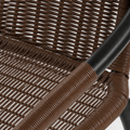 Texture | extreme close-up of dark-brown open resin-rattan weave and black steel chair hoop