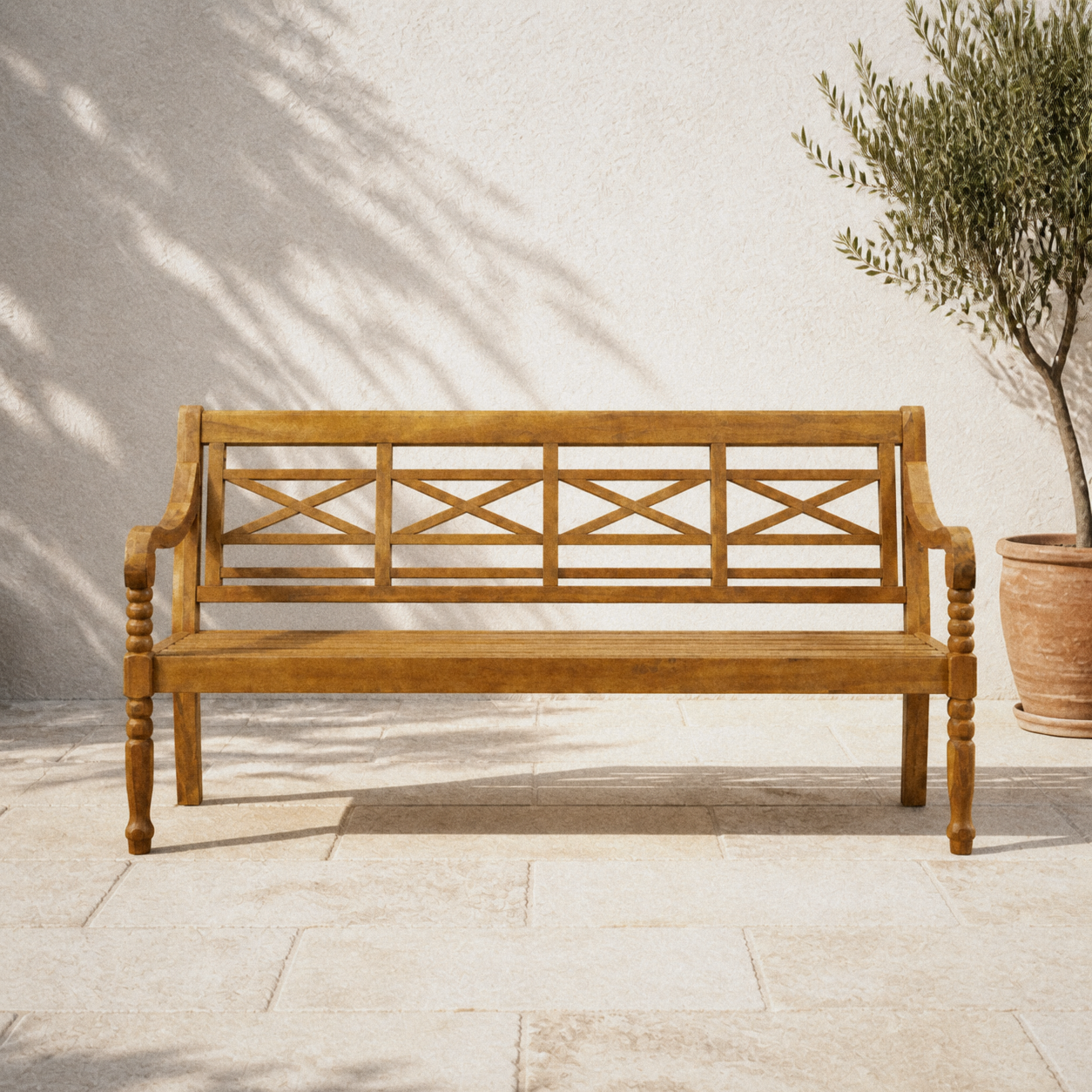 Courtyard | natural acacia garden bench on pale limestone by a limewashed wall and olive tree