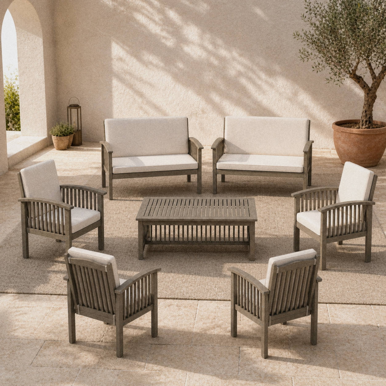 Courtyard | two cream-cushioned loveseats, four armchairs, and a slat-top coffee table on limestone pavers