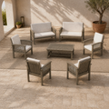 Complete set | courtyard view of two loveseats, four armchairs, and the low slat-top coffee table