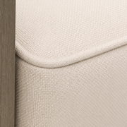Cushion material detail | cream woven cushion fabric with matching piping beside gray-washed acacia