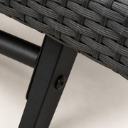 Hardware | close view of a black powder-coated iron lounger support with its round bolt beneath gray wicker