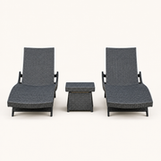 Front | front studio view of two charcoal-gray woven chaise loungers with a matching side table