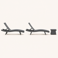 Side | side studio view of two charcoal-gray woven chaise loungers with a matching side table