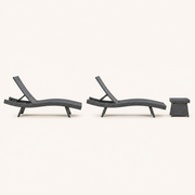 Side | side studio view of two charcoal-gray woven chaise loungers with a matching side table