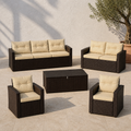 Courtyard | dark brown wicker sofa, loveseat, two armchairs, and closed storage table on pale stone beneath an olive tree