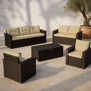Complete set | dark brown wicker sofa, loveseat, two armchairs, and closed storage table on a stone courtyard