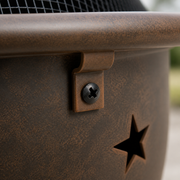 Hardware | extreme close view of tubular ring, bracket lug, dark screw, weathered bronze patina and star cutout