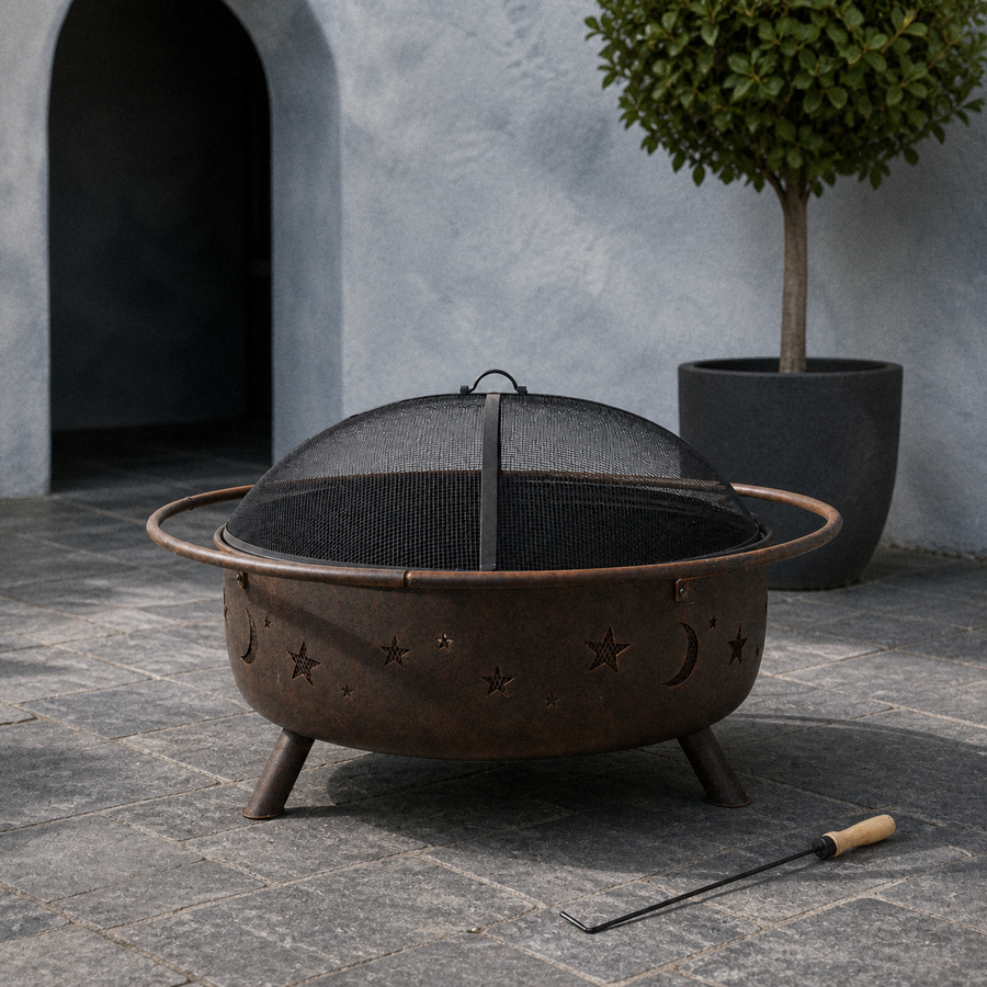 In a room | cool slate courtyard view of bronze fire pit with mesh screen seated and poker at right