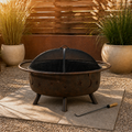 In a room | warm cedar garden court with bronze fire pit, black mesh screen and poker