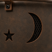 Texture | extreme close view of weathered bronze bowl patina with star and crescent cutouts and mesh