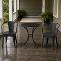 In a room | rainy green veranda with black iron bistro table and two armchairs