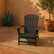 Terracotta garden | black Adirondack chair on a clay-tile courtyard