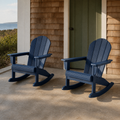 Coastal porch | two navy blue rocking Adirondack chairs in front of cedar shingles and a sage green door
