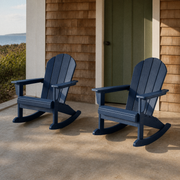 Coastal porch | two navy blue rocking Adirondack chairs in front of cedar shingles and a sage green door