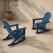 Terrace angle | two navy blue rocking Adirondack chairs on limestone pavers beneath an olive tree