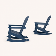 Studio side | two navy blue rocking Adirondack chairs in side profile with raked backs and curved runners