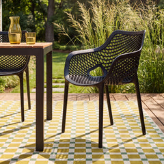 Room | The Wulfern Viokastro Mesh Stacking Dining Armchairs, Set of 2 in a styled room
