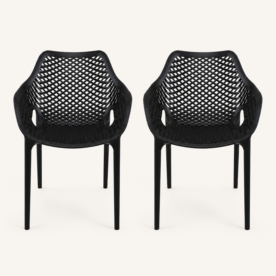 Studio front | two matte-black open-mesh armchairs, front view, on a warm-white studio ground