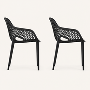 Studio side | two matte-black open-mesh armchairs in full side profile