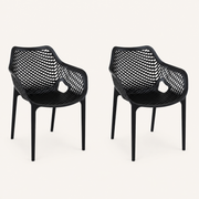 Studio three-quarter | two matte-black open-mesh armchairs turned to show the seat depth and arm openings