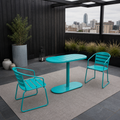 In a room | teal oval folding bistro set on a charcoal rooftop terrace with slate paving