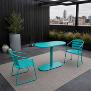 In a room | teal oval folding bistro set on a charcoal rooftop terrace with slate paving