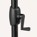 Hardware | close-up of black crank housing and L-shaped handle on textured black umbrella pole