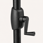 Hardware | close-up of black crank housing and L-shaped handle on textured black umbrella pole