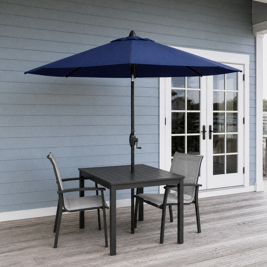 In a room | navy market umbrella over black slatted table on blue-gray porch before French doors