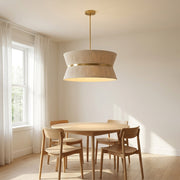 In a room | beige cinched drum chandelier hanging over a round wood table