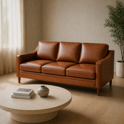 Living room angle | Front-left view of the chestnut three-seat sofa with a round stone coffee table