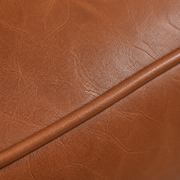 Faux leather texture | Macro of chestnut faux-leather grain and a piped seam