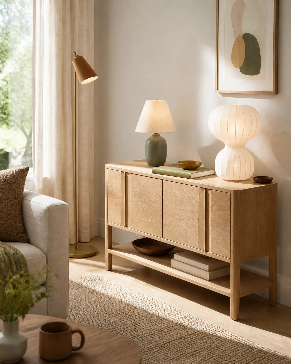 Ivory and muted olive lamps with aged brass on a light oak console
